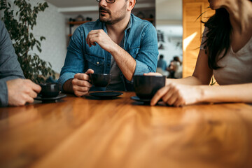 People having coffee, close-up, copy space.