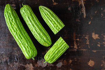 .Fresh bitter gourd on a wooden background