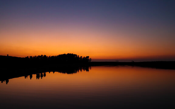 Beautiful landscape of sunset reflected on a lake on summer © mamorshedalam