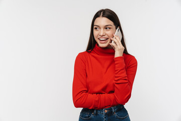 Photo of happy young woman smiling while talking on mobile phone