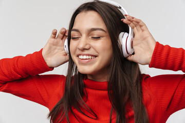Photo of happy caucasian woman smiling while using headphones
