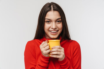 Photo of cheerful brunette woman laughing and holding cup