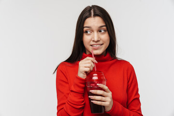 Photo of pleased brunette woman drinking soda from plastic glass