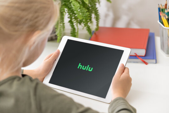 January 5, 2020, Kaliningrad, Russia. Young Girl Holding IPad In Her Hands With Hulu Application On The Screen. Hulu Is A Subscription Video On-demand Streaming Service