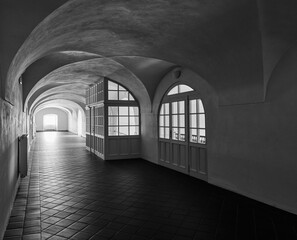 Black and White depressive corridor with wooden windows and historical ceiling vault, Broumov monastery, Czech Republic