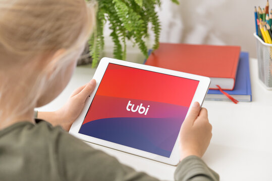 January 5, 2020, Kaliningrad, Russia. Young girl holding iPad in her hands with TUBI application on the screen. TUBI is a subscription video on-demand streaming service