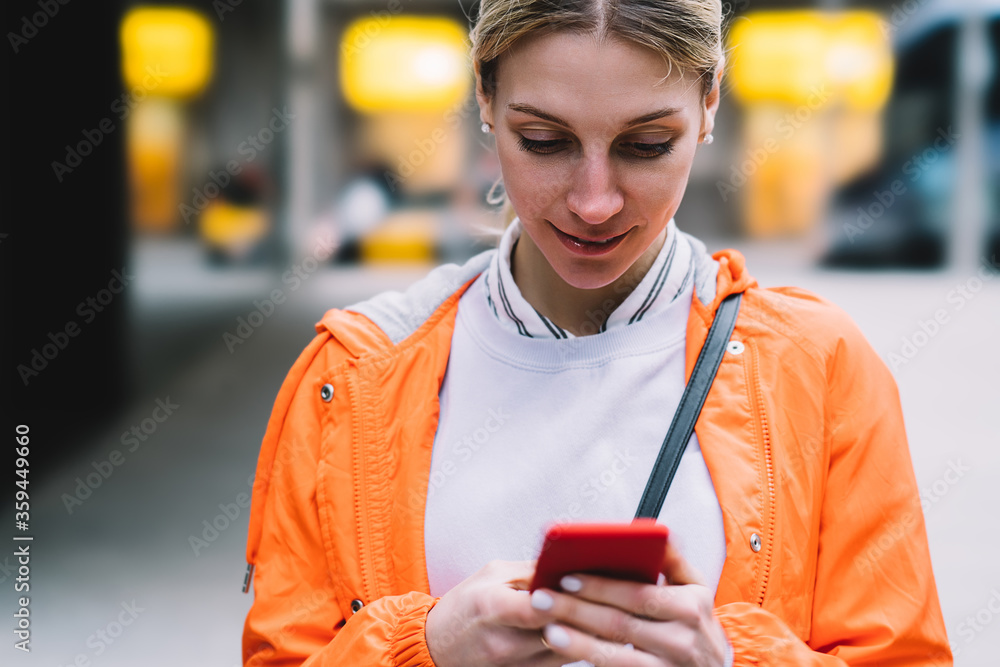 Aufkleber close up view of young female using mobile phone data internet connection while standing on city str