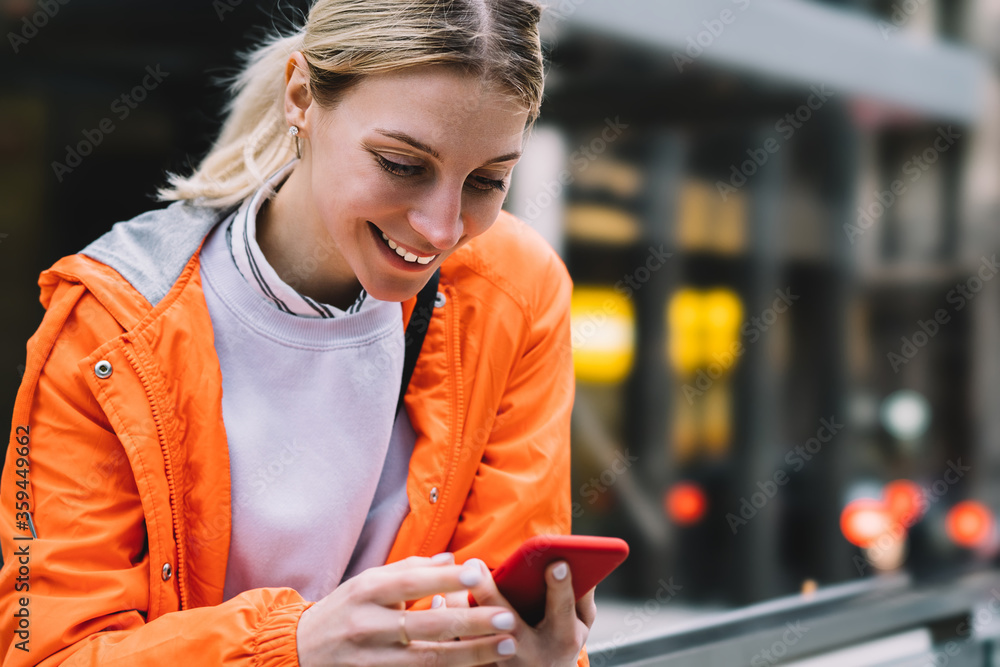 Aufkleber close up view of young female using mobile phone data internet connection while standing on city str
