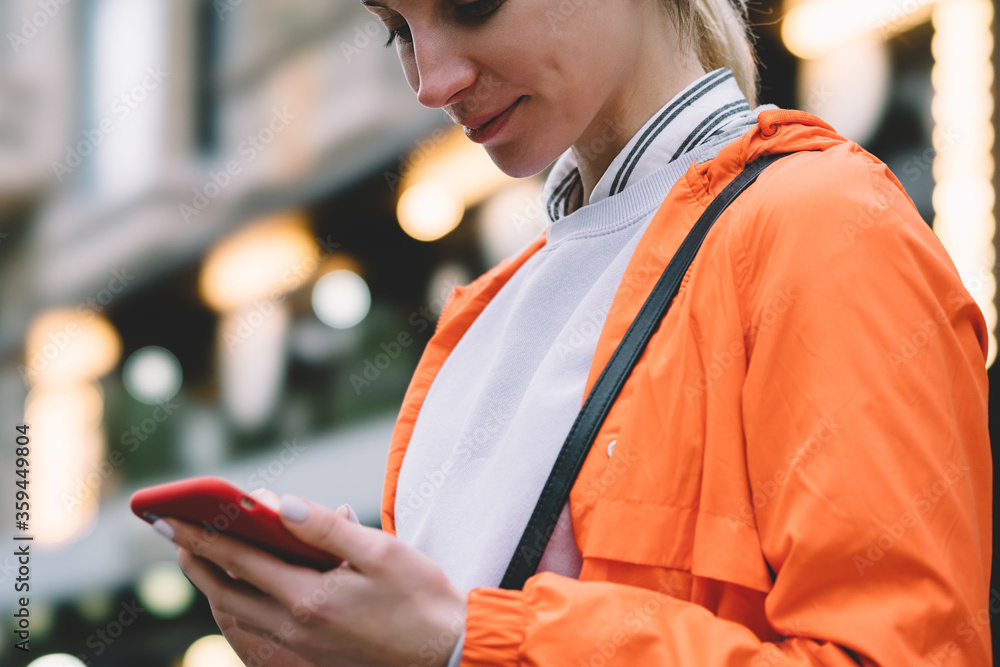 Aufkleber close up view of young female using mobile phone data internet connection while standing on city str