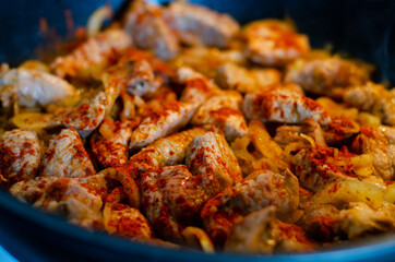 Sliced ​​meat fried in a pan.