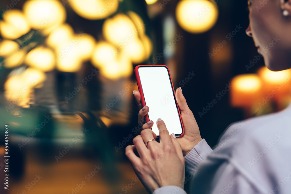 Aufkleber back close up view of female person holding cellphone with big blank screen and reading informations