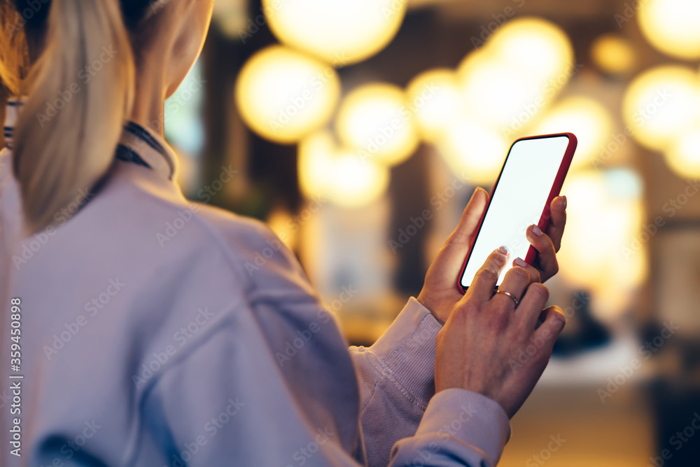 Aufkleber side close up view of female person holding in hands cellular with big blank screen while standing o