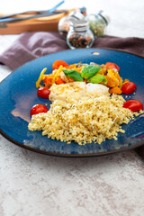 cod fish with vegetables, small vegetables and marine sauce