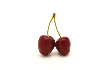 Two ripe sweet cherries on a light background. Natural product. Close-up.
