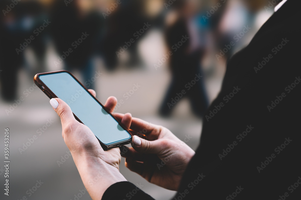 Poster cropped view of woman's hands holding modern smartphone with mock up area and installing app using 4
