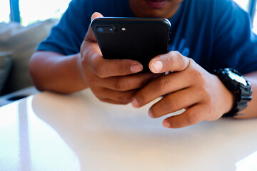 Cropped shot view of business man’s hands typing the labtop and holding smart phone with blank copy space screen for your information content or text message.