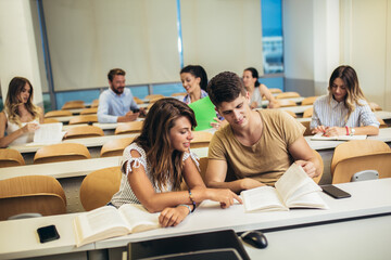 University students studying together in classroom.