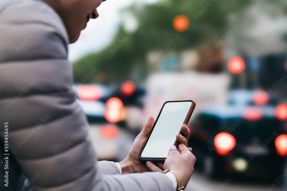 Poster cropped view of young woman holding modern smartphone device with blank screen area for your interne