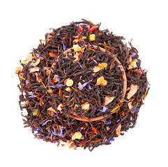 Black Ceylon tea with candied fruit, saffron, rose and cornflower petals, isolated on white background. Organic tea. Top view. Close up.