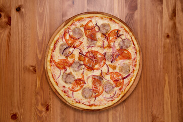 Pizza on a wooden background. Top view.