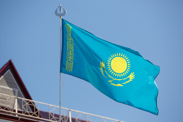 The flag of the Republic of Kazakhstan against the sky