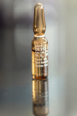 Vitamin D oral ampoule for immune system of our body for coronavirus on a black table, close up, macro photography