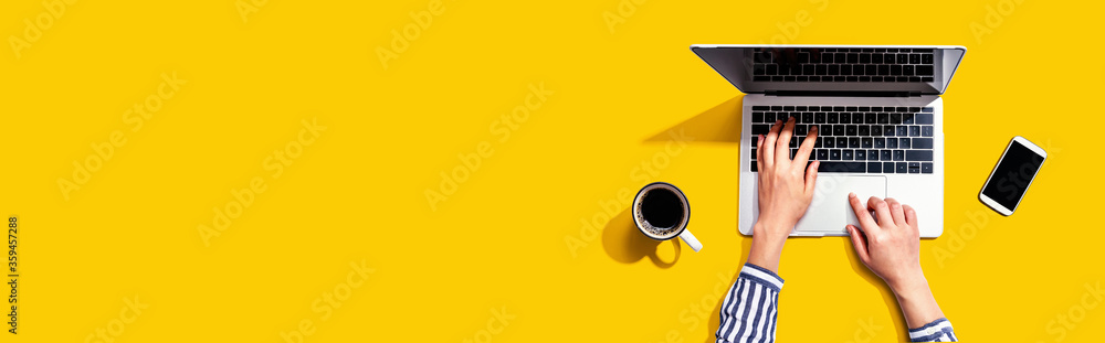 Poster person using a laptop computer from above