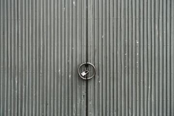 Grungy weathered grey metallic doors. Old weathered iron gate.