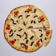 Pizza with cut off slice on a white background. Top view.