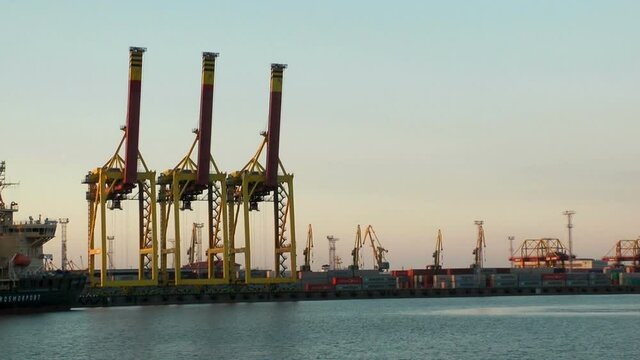 Russia, Saint Petersburg, June 19, 2020: Seaport, cranes, ships and containers. Marine cargo transportation industry.