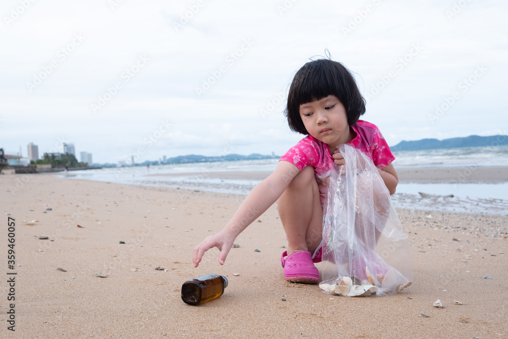 Wall mural children pick up trash on the beach, dirty sea