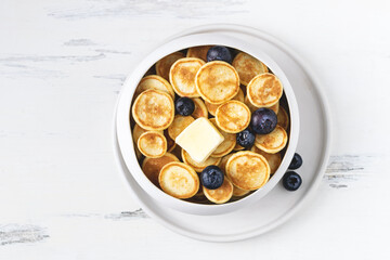 Food cooking trend, pancake cereal, tiny pancakes with raspberry, blueberry