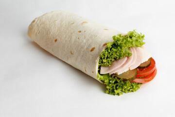 Hot roll with ham lettuce, cucumber and tomatoes. Close-up