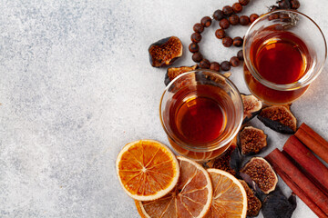 Cup of tea decorated with pieces of dried orange and fig