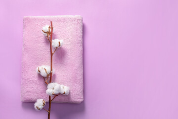 Fototapeta na wymiar Pink bath towel with cotton branch