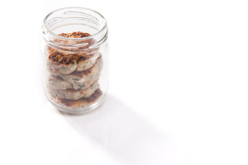 Fototapeta na wymiar Nutrition concept - Healthy food, Diet, Detox, Clean Eating or Vegetarian concept. A nutritious food on glass jars against white background. Meat balls in a jar.
