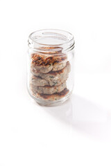Nutrition concept - Healthy food, Diet, Detox, Clean Eating or Vegetarian concept. A nutritious food on glass jars against white background. Meat balls in a jar.