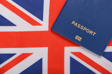 Travel concept. Passport against the background of the British flag