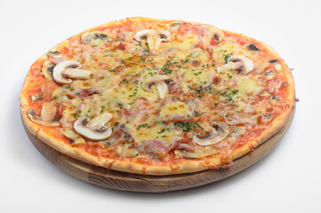 Ham monty pizza. Filed on a wooden board with a white background. Ingredients: mozzarella cheese, pesto sauce, herbs, ham, mushrooms.