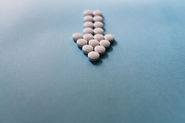 Tablets shaping an arrow on blue background.