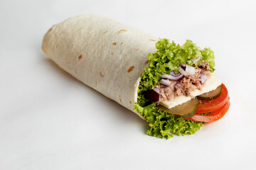 Hot roll with tuna, onion, lettuce, cucumber and tomatoes. Close-up