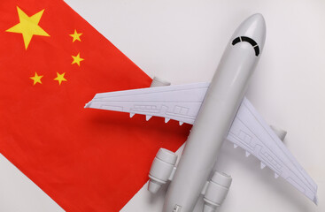 Travel concept. Passenger plane and China flag on white background