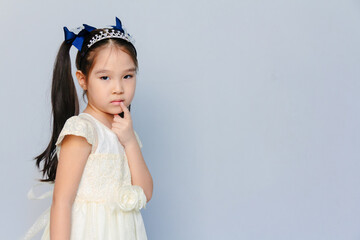 Portrait of a cute 6 years old Asian girl thinking 