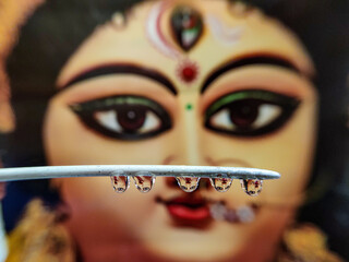Durga in water drop under stick