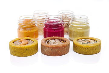 Nutrition concept - Healthy food, Diet, Detox, Clean Eating or Vegetarian concept. Glasses of food and small quiches. Nutritious food against white background. 