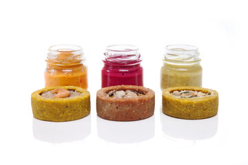 Nutrition concept - Healthy food, Diet, Detox, Clean Eating or Vegetarian concept. Glasses of food and small quiches. Nutritious food against white background. 