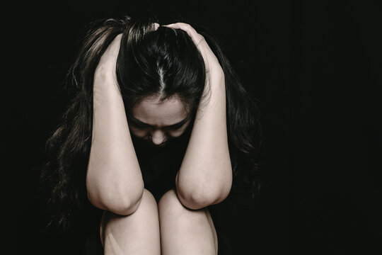 Asian woman in emotional distress experiencing depression, loneliness, tiredness, weakness, sadness pose
