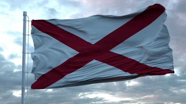 Flag of Alabama waving in the wind against deep beautiful clouds sky. 3d rendering