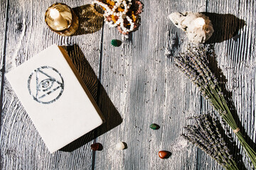 white magic book laying on the table with rosaries, lavender. Concept of fortune telling, ritual, altar, spiritism, secret knowledge
