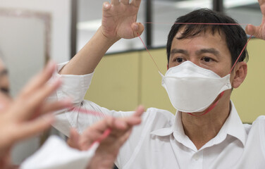 Respirator fit test prepared for COVID-19. Asia man testing repiratory system with N-95 surgical...